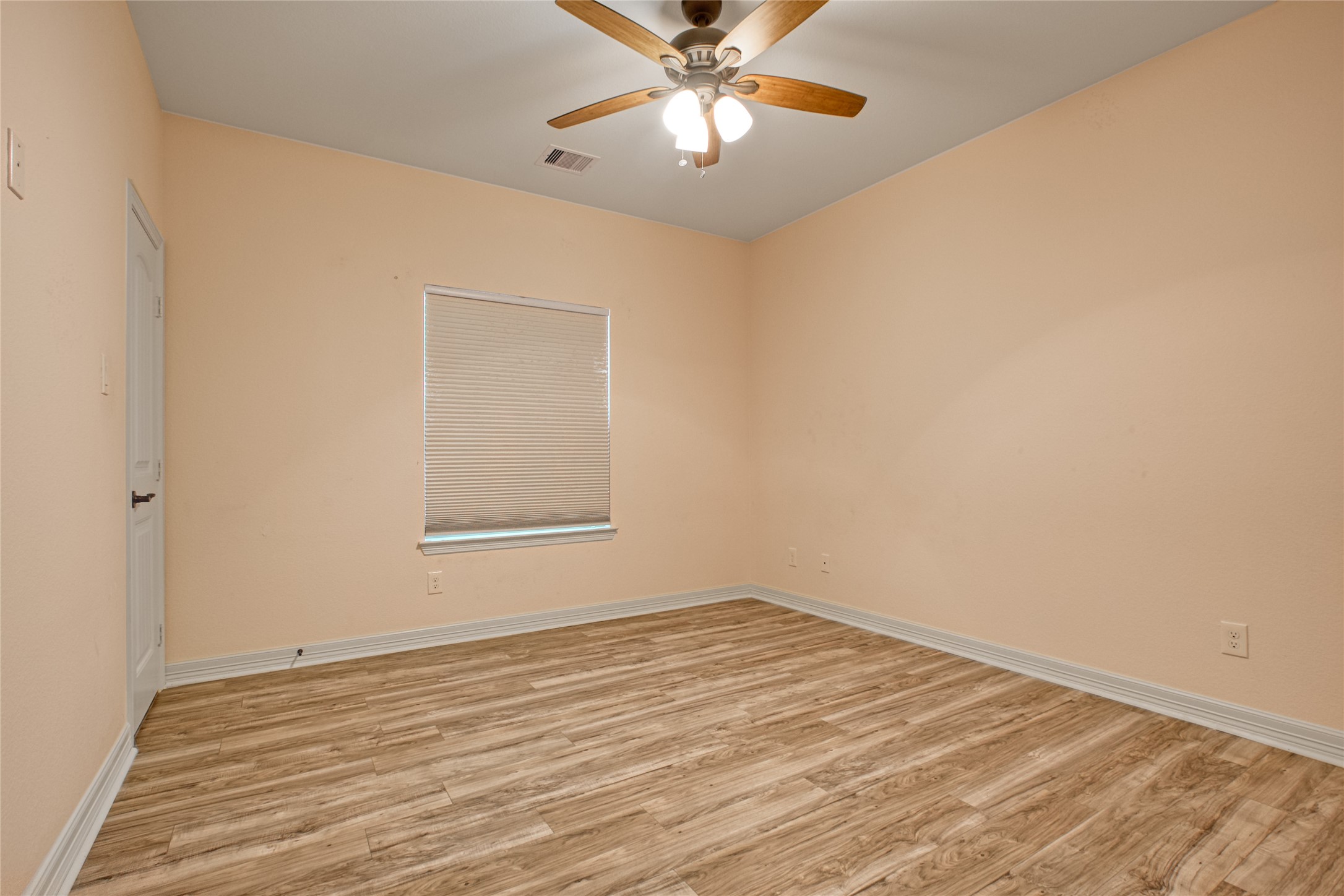 27684 Rio Blanco Drive Splendora, TX 77372 - Photo 23 of 31 a view of an empty room with window and wooden floor