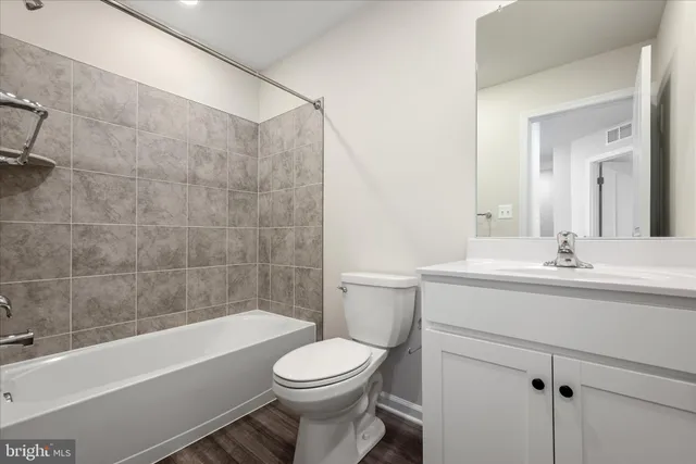 a bathroom with a sink a toilet and bathtub