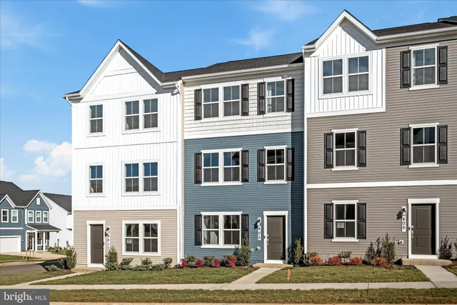 a front view of a residential apartment building with a yard