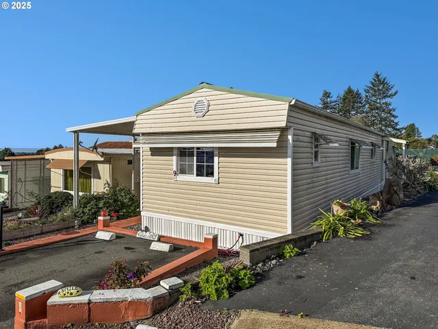 a front view of a house with plants