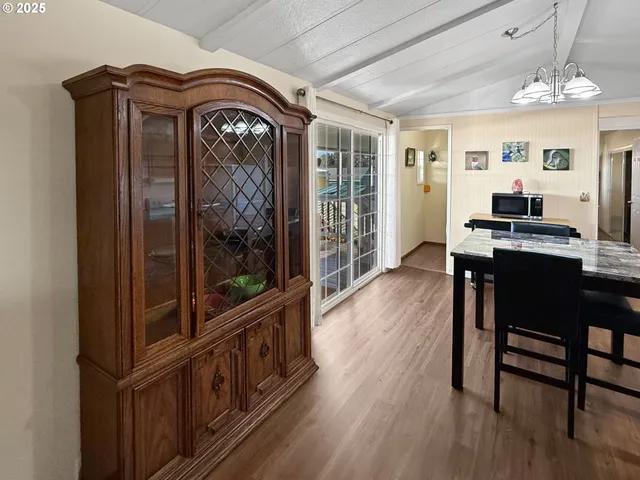 a view of a hallway view with furniture window and wooden floor