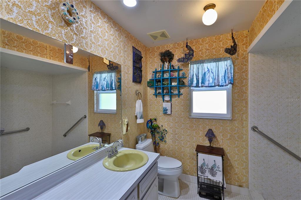 109 Satsuma Drive Altamonte Springs, FL 32714 - Photo 11 of 20 a bathroom with a sink toilet a mirror and vanity
