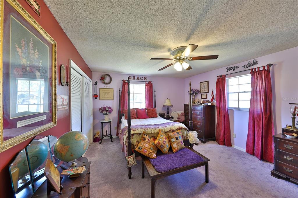 109 Satsuma Drive Altamonte Springs, FL 32714 - Photo 12 of 20 a bedroom with furniture and a chandelier