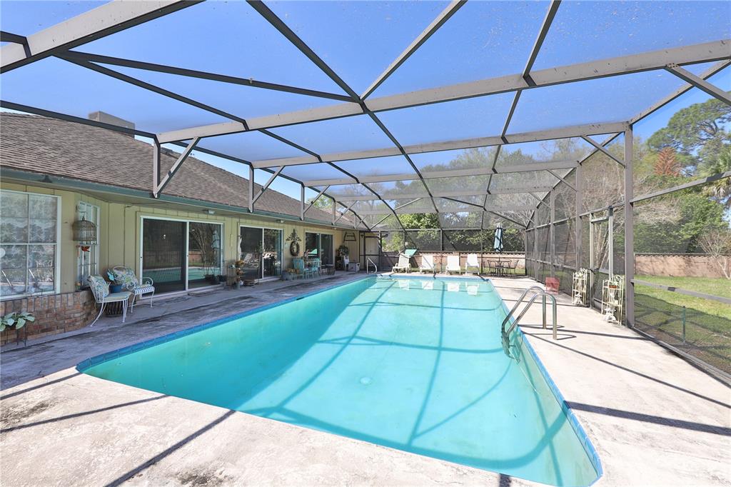 109 Satsuma Drive Altamonte Springs, FL 32714 - Photo 2 of 20 a view of a backyard with table and chairs under an umbrella