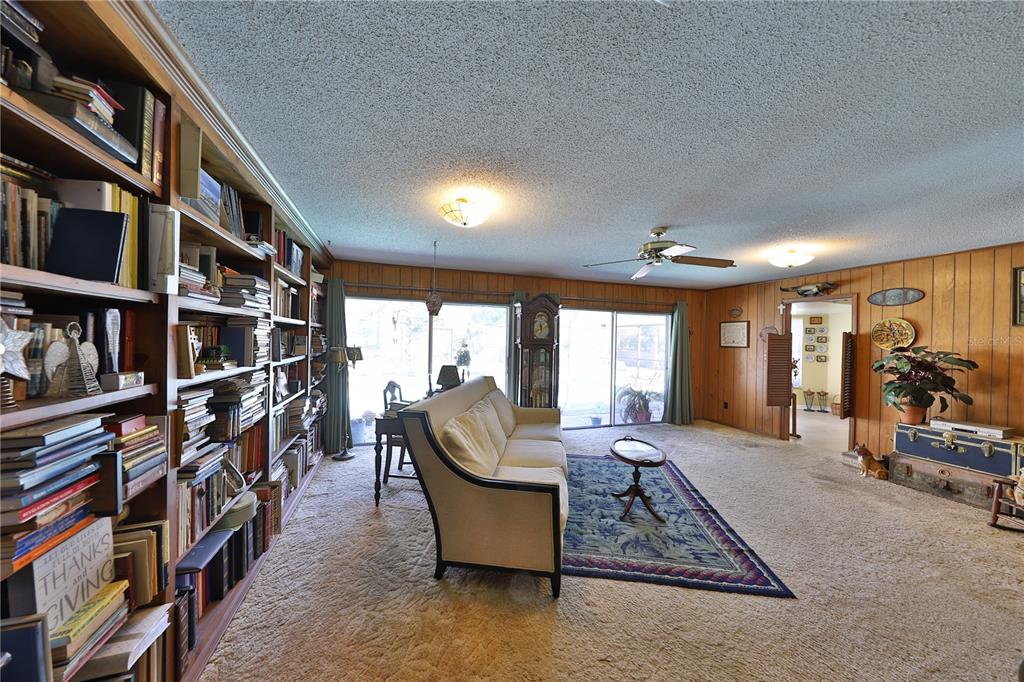 109 Satsuma Drive Altamonte Springs, FL 32714 - Photo 5 of 20 a living room with furniture a rug and a book shelf