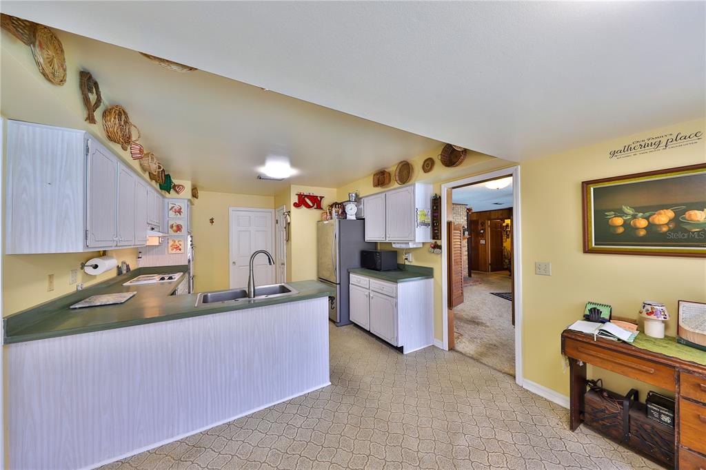 109 Satsuma Drive Altamonte Springs, FL 32714 - Photo 6 of 20 a kitchen with kitchen island granite countertop a sink and counter top space
