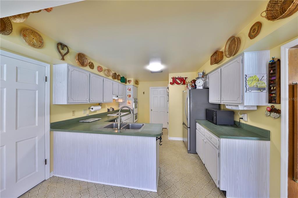 109 Satsuma Drive Altamonte Springs, FL 32714 - Photo 7 of 20 a kitchen with stainless steel appliances granite countertop a sink and a refrigerator
