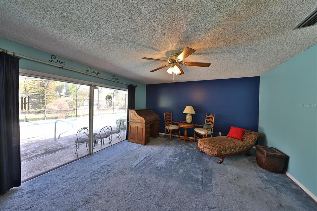 109 Satsuma Drive Altamonte Springs, FL 32714 - Photo 10 of 20 a living room with furniture and a floor to ceiling window