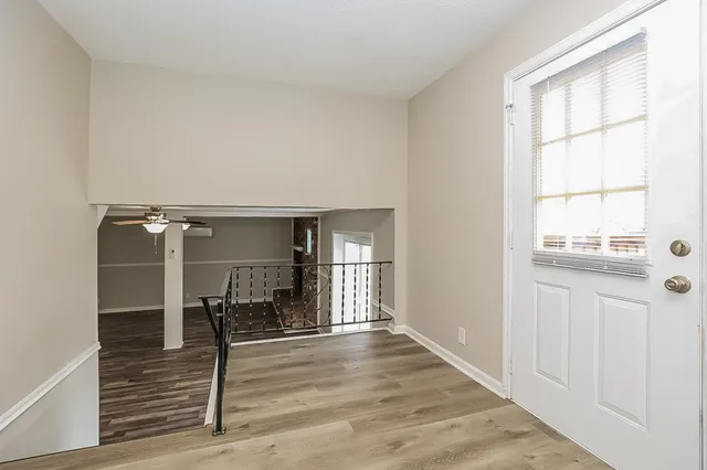 a view of a livingroom with wooden floor and a window