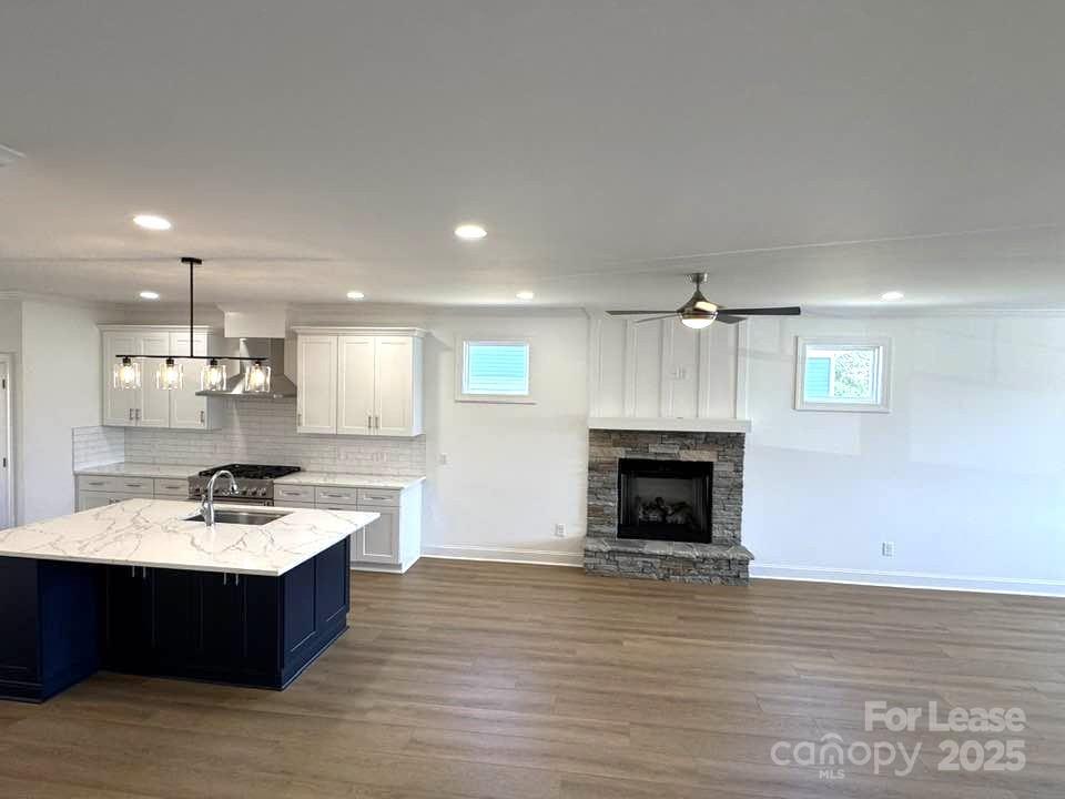 8070 Blackwood Road Denver, NC 28037 - Photo 12 of 39 a large kitchen with a sink and a fireplace