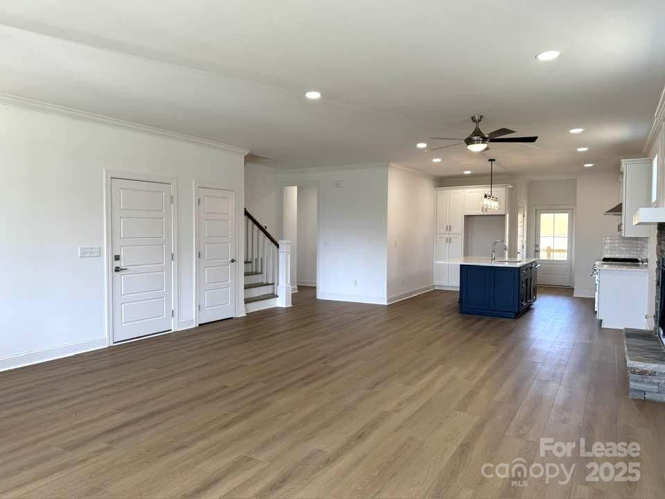8070 Blackwood Road Denver, NC 28037 - Photo 13 of 39 a view of a big room with wooden floor and a kitchen