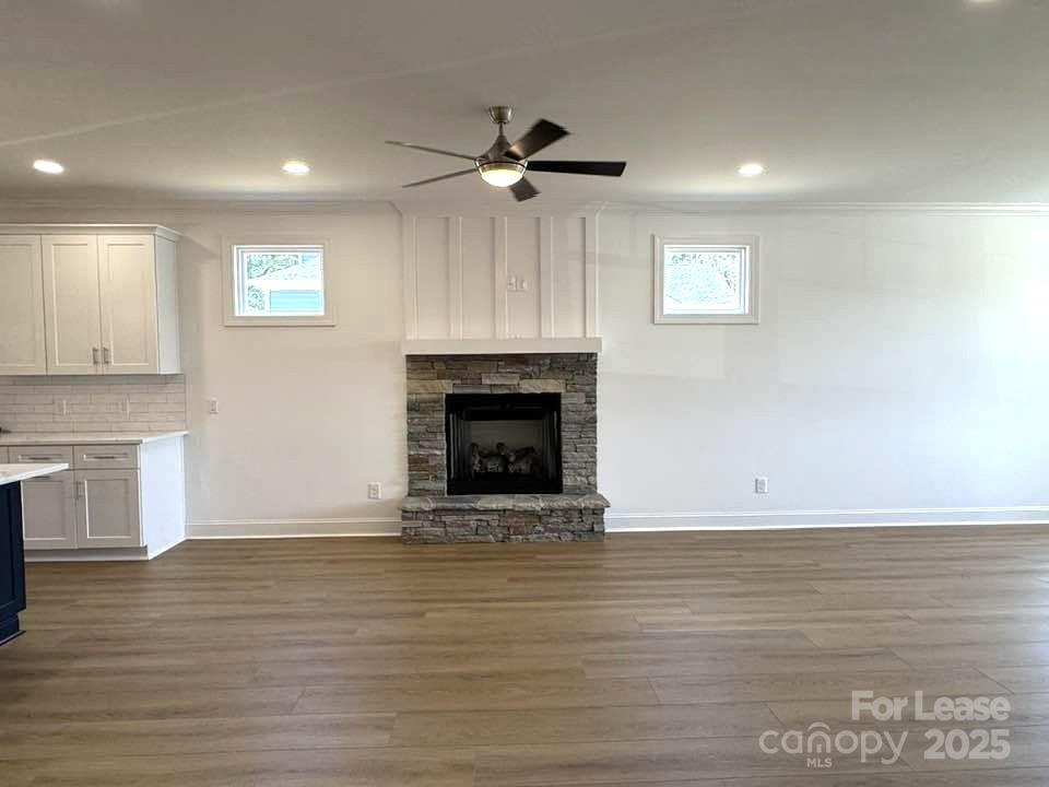 8070 Blackwood Road Denver, NC 28037 - Photo 16 of 39 a view of an empty room with wooden floor fireplace and a window