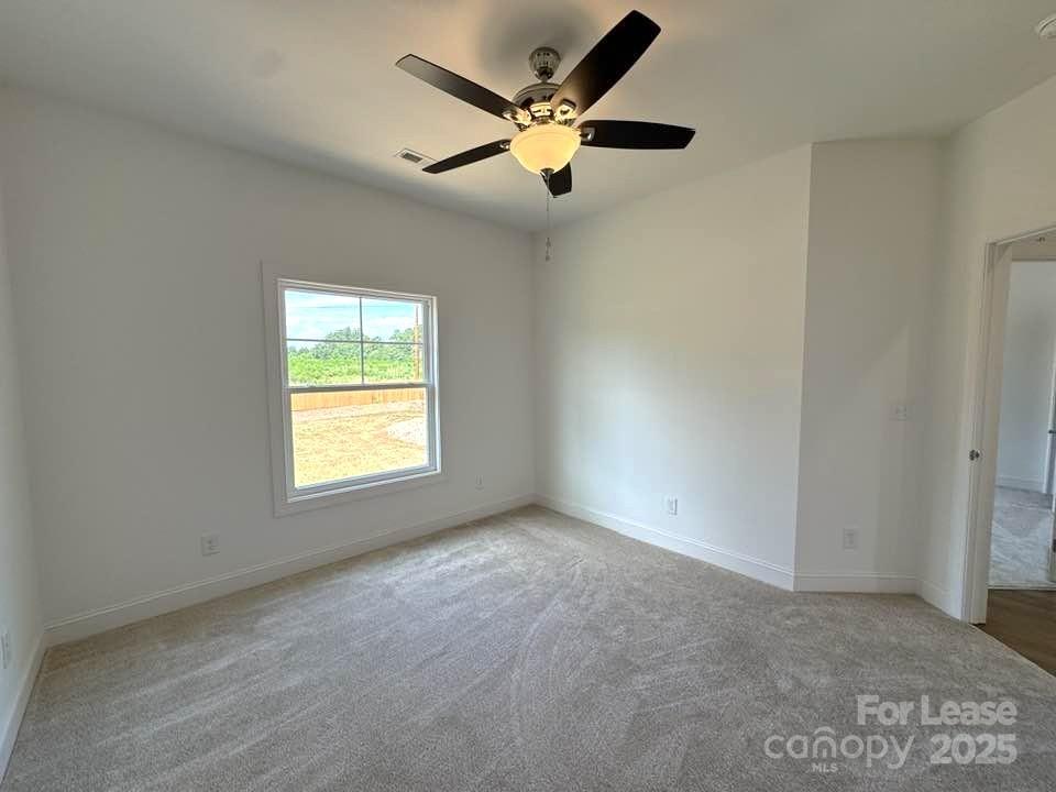 8070 Blackwood Road Denver, NC 28037 - Photo 24 of 39 an empty room with a ceiling fan and window