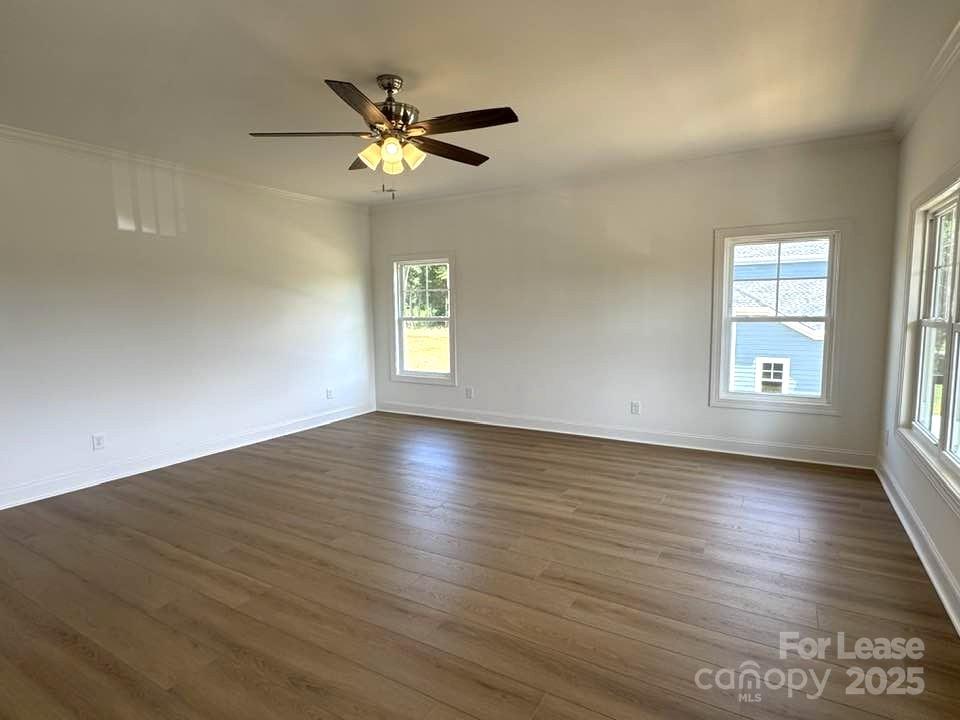 8070 Blackwood Road Denver, NC 28037 - Photo 28 of 39 a view of an empty room with wooden floor and a window