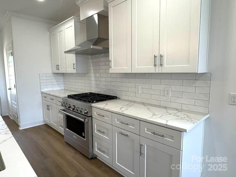 8070 Blackwood Road Denver, NC 28037 - Photo 3 of 39 a kitchen with cabinets appliances and a wooden floor