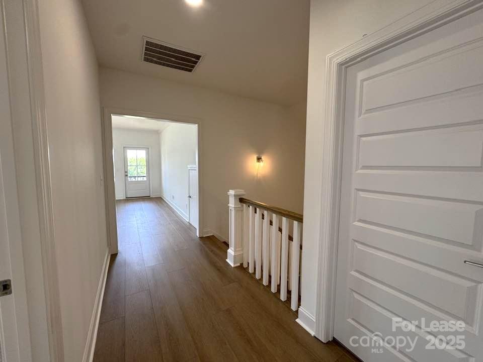 8070 Blackwood Road Denver, NC 28037 - Photo 32 of 39 a view of a hallway with wooden floor