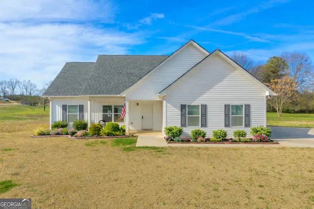 a front view of a house with garden