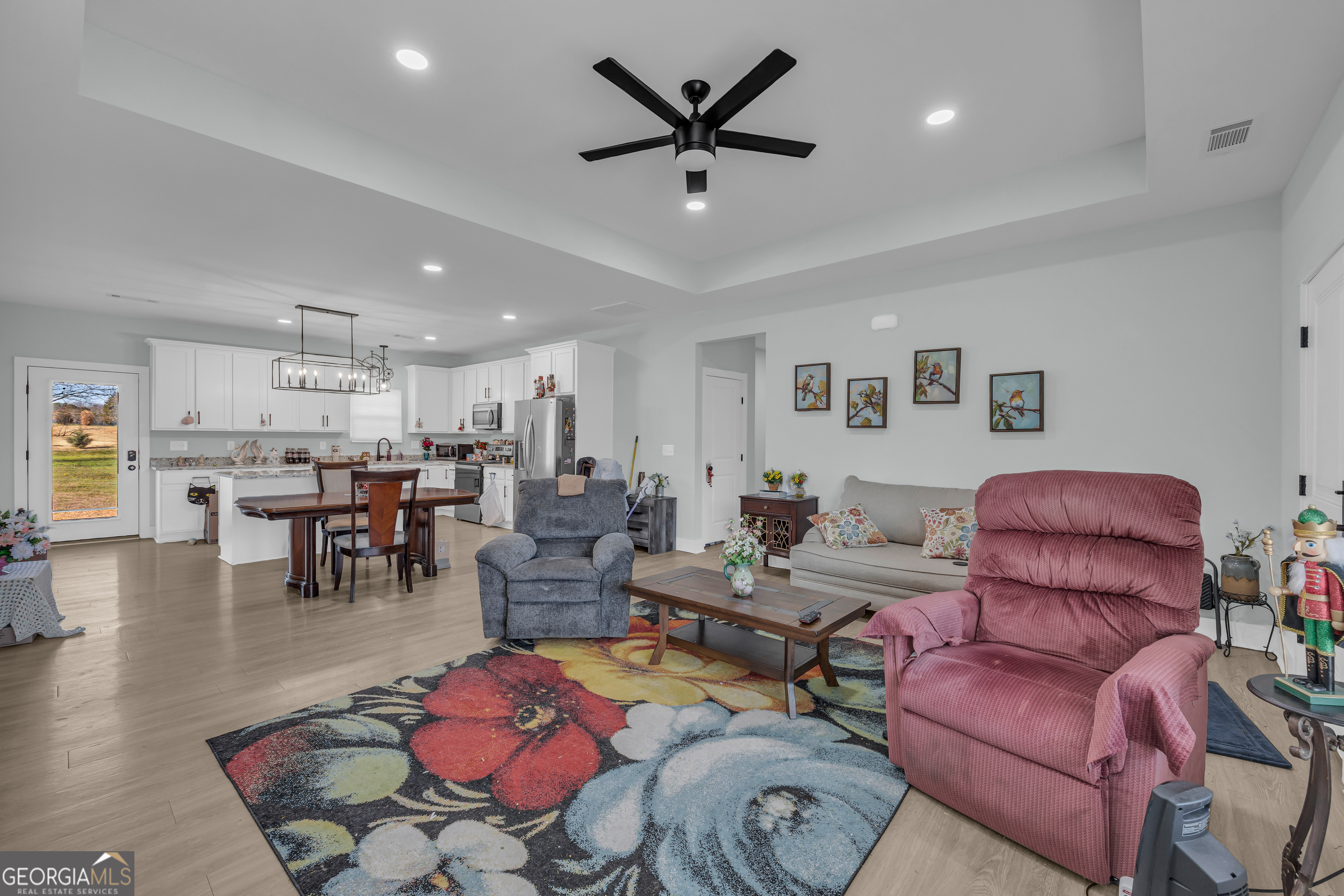 1279 South Fairview Road Lavonia, GA 30553 - Photo 11 of 43 a living room with furniture kitchen view and a chandelier