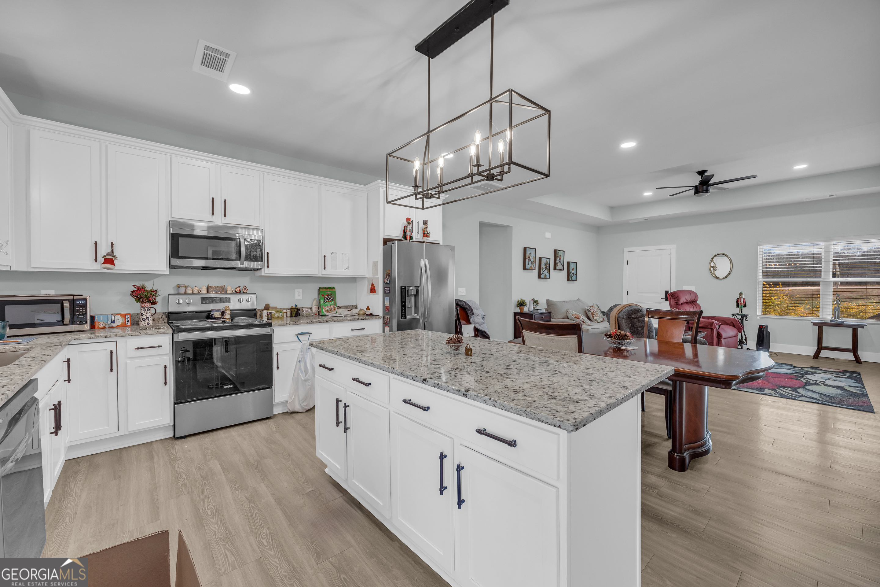 1279 South Fairview Road Lavonia, GA 30553 - Photo 16 of 43 a kitchen with stainless steel appliances granite countertop a stove refrigerator and cabinets