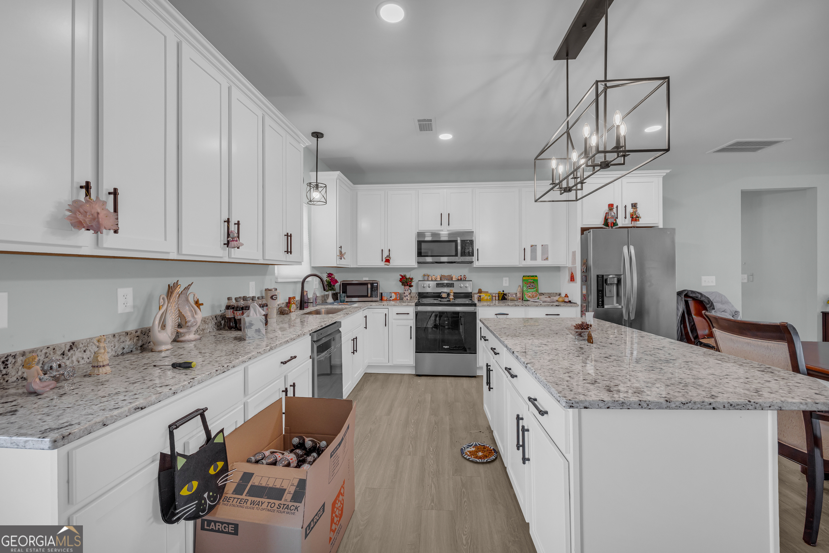 1279 South Fairview Road Lavonia, GA 30553 - Photo 18 of 43 a kitchen with granite countertop a sink a counter space cabinets and stainless steel appliances