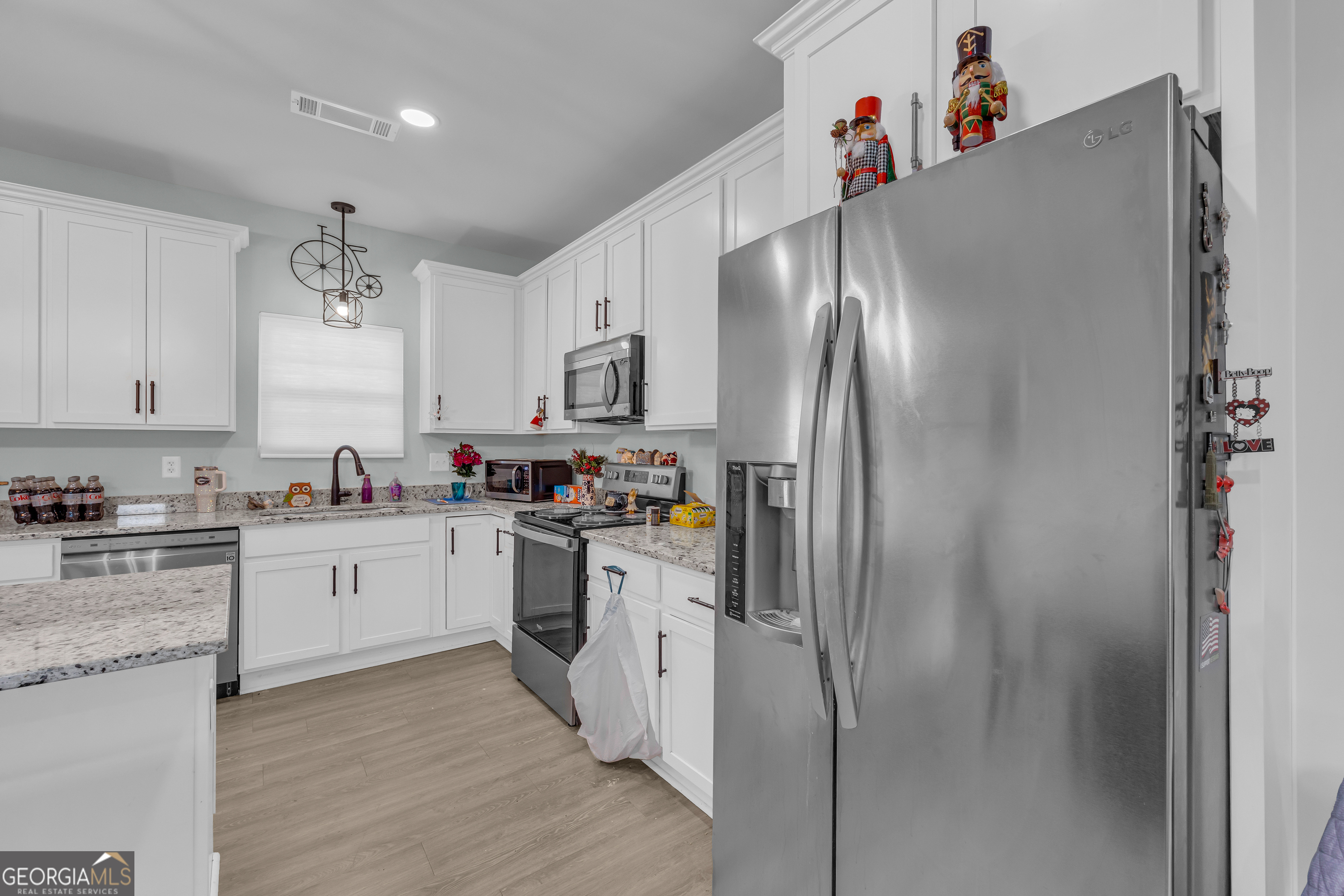 1279 South Fairview Road Lavonia, GA 30553 - Photo 19 of 43 a kitchen with stainless steel appliances a refrigerator sink and cabinets