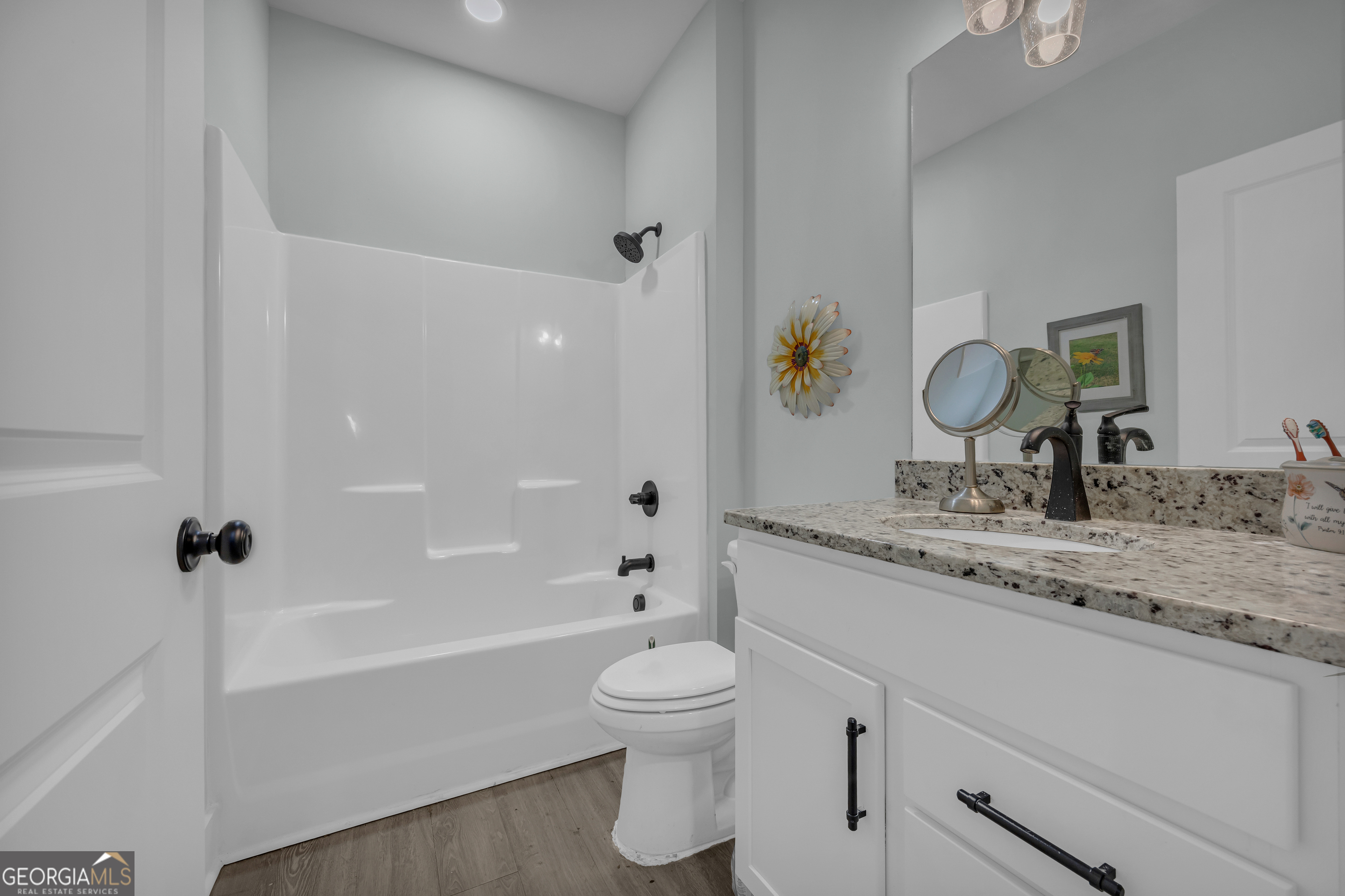 1279 South Fairview Road Lavonia, GA 30553 - Photo 26 of 43 a bathroom with a granite countertop sink a toilet and shower