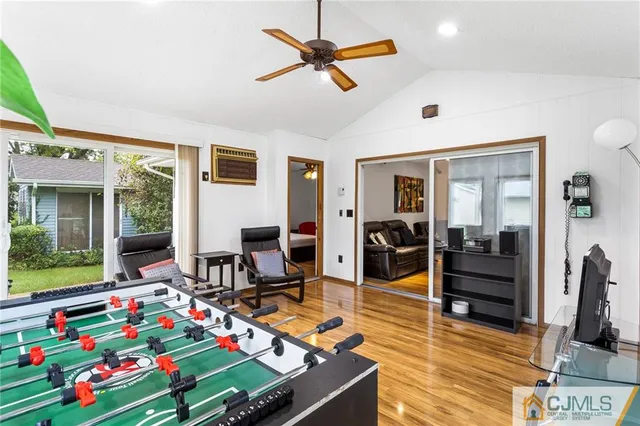 a room with musical instrument pool table and windows