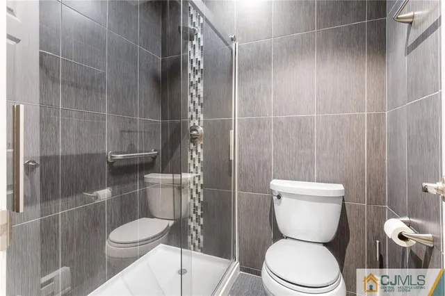 a white toilet sitting next to a bathroom sink