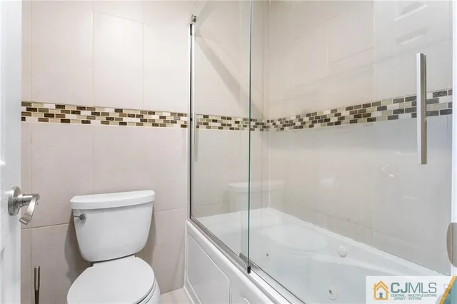 a bathroom with a toilet and a bathtub