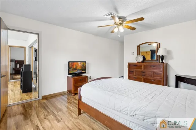 a bedroom with a bed and a dresser