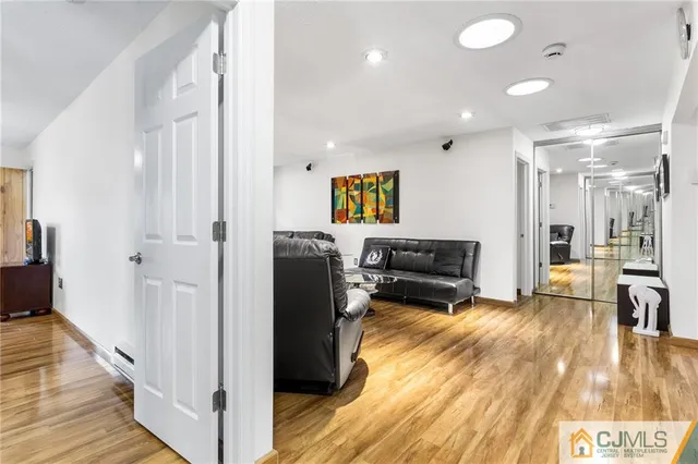 a living room with furniture and a wooden floor