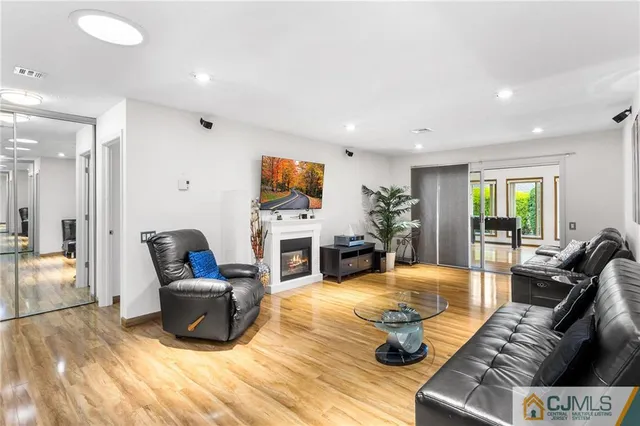 a living room with fireplace furniture and a wooden floor