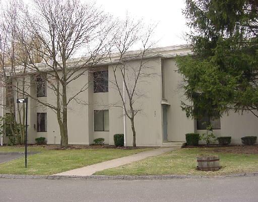 56 Olcott Way, Unit 56 Ridgefield, CT 06877 - Photo 1 of 1 a white house that has a tree in front of it