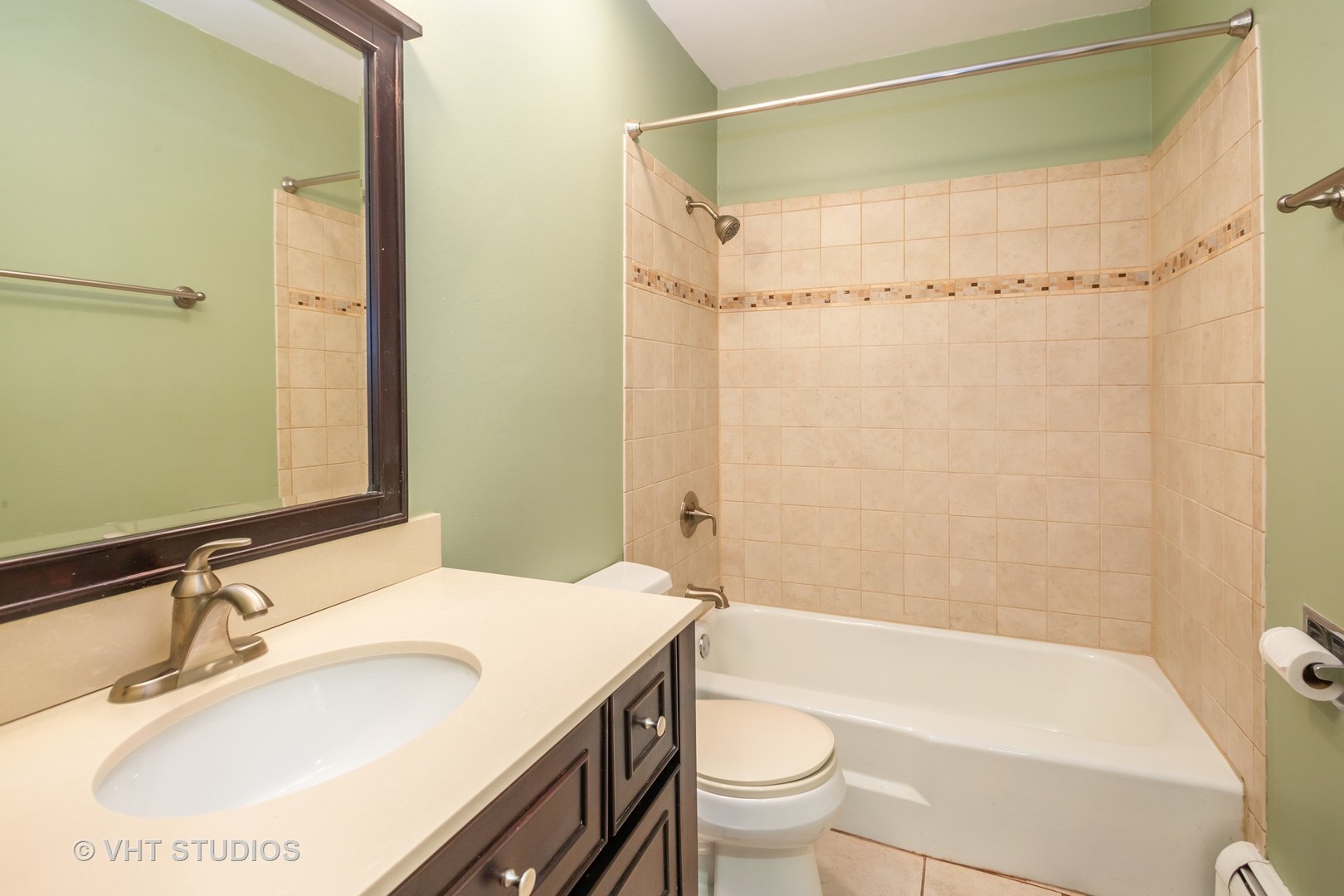 2323 South Goebbert Road, Unit 207 Arlington Heights, IL 60005 - Photo 11 of 12 a bathroom with a sink a mirror toilet and bathtub