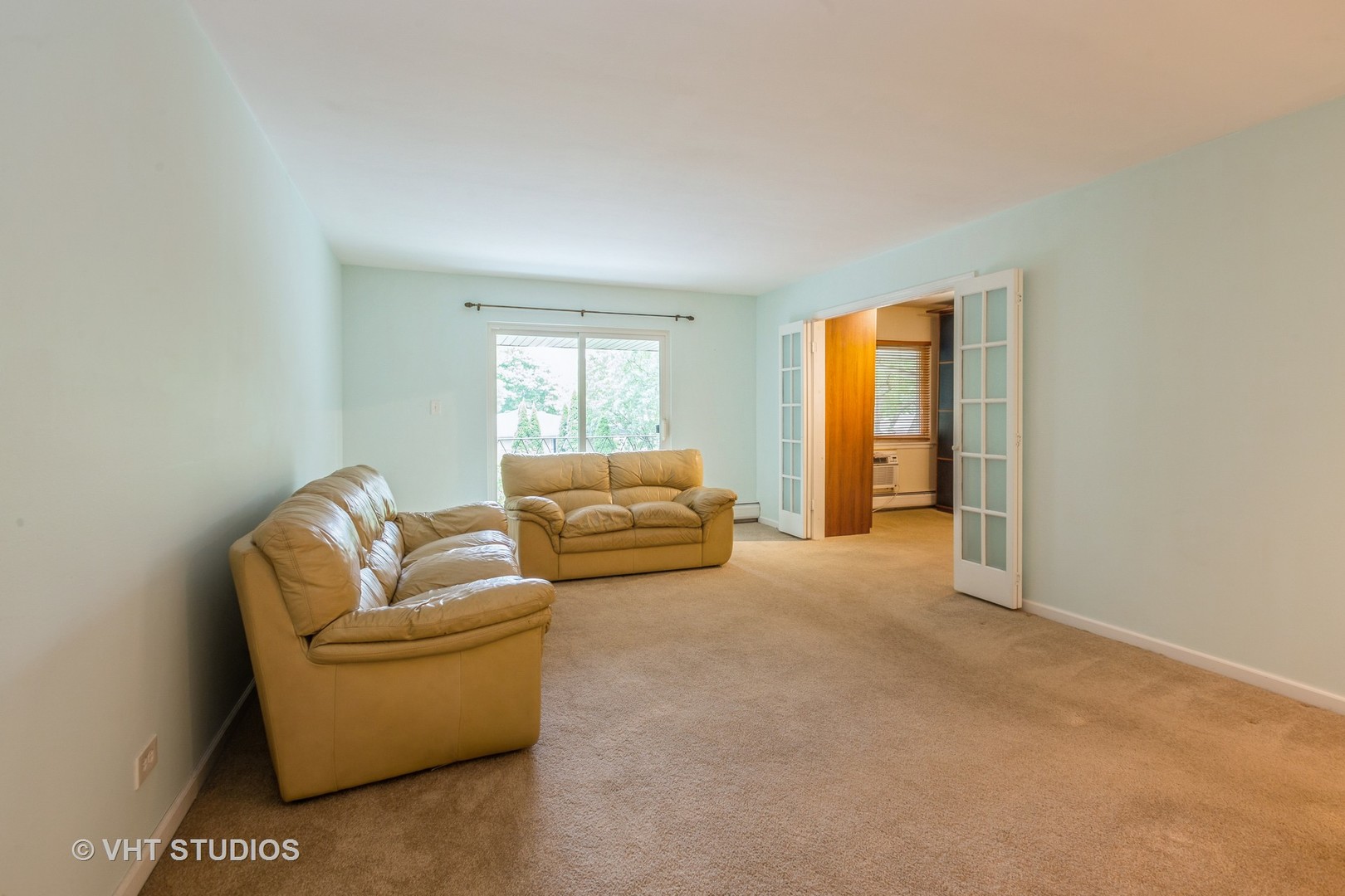 2323 South Goebbert Road, Unit 207 Arlington Heights, IL 60005 - Photo 2 of 12 a living room with furniture and a window