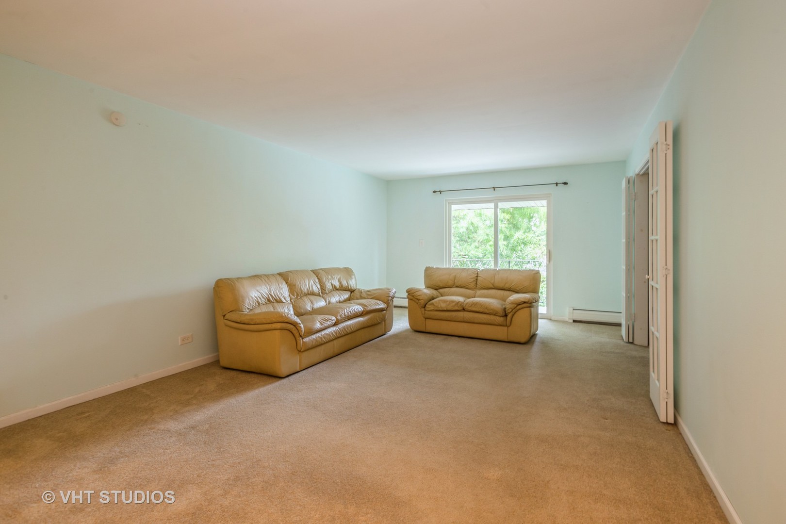 2323 South Goebbert Road, Unit 207 Arlington Heights, IL 60005 - Photo 3 of 12 a living room with furniture and a window