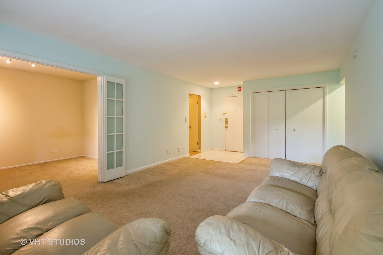 2323 South Goebbert Road, Unit 207 Arlington Heights, IL 60005 - Photo 4 of 12 a bed room with a bed and a couch