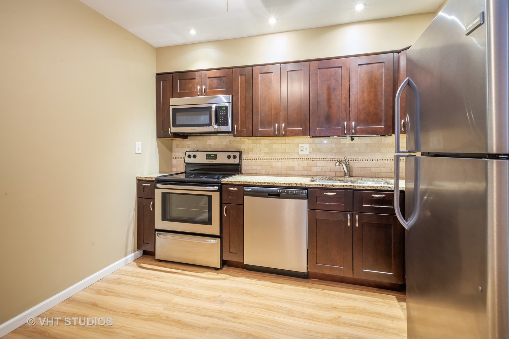 2323 South Goebbert Road, Unit 207 Arlington Heights, IL 60005 - Photo 6 of 12 a kitchen with stainless steel appliances granite countertop a refrigerator stove and sink