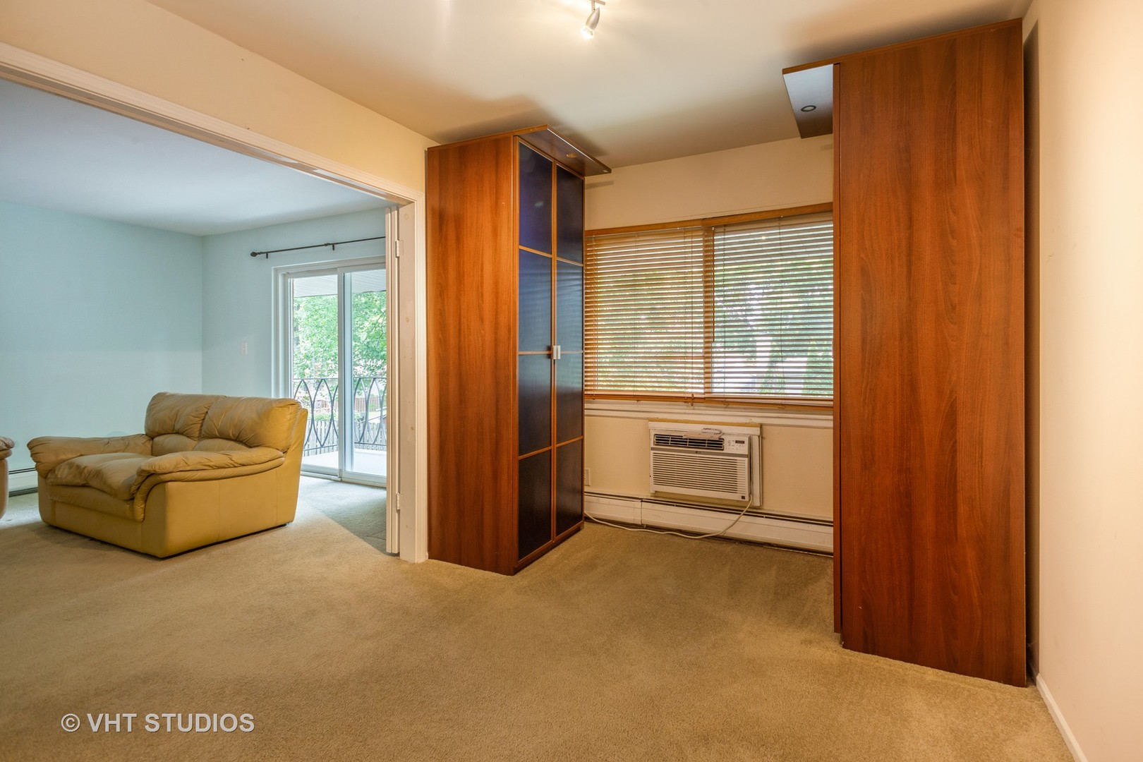 2323 South Goebbert Road, Unit 207 Arlington Heights, IL 60005 - Photo 8 of 12 a living room with furniture a flat screen tv and a fireplace