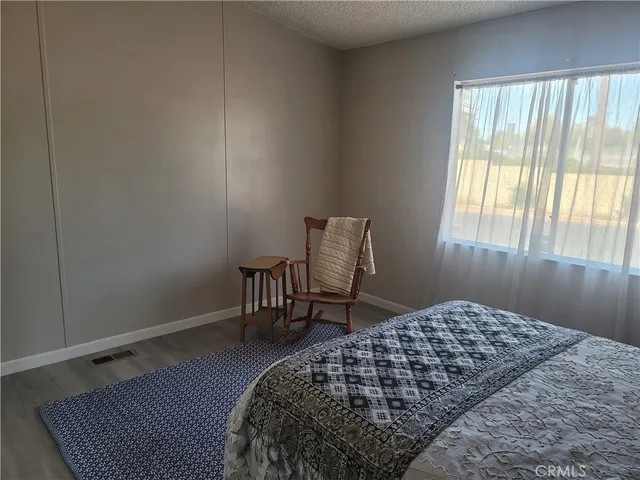a bedroom with a bed and chair