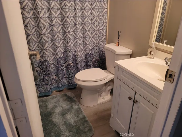 a white toilet sitting next to a small sink