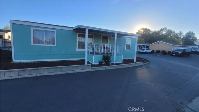 a view of a house with a patio and a yard