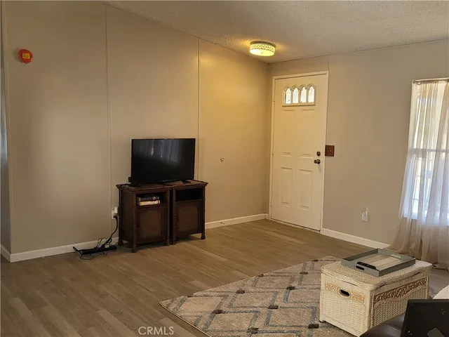 a bedroom with a bed and a television