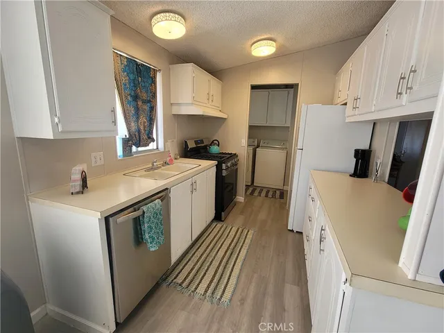 a utility room with sink dryer and washer