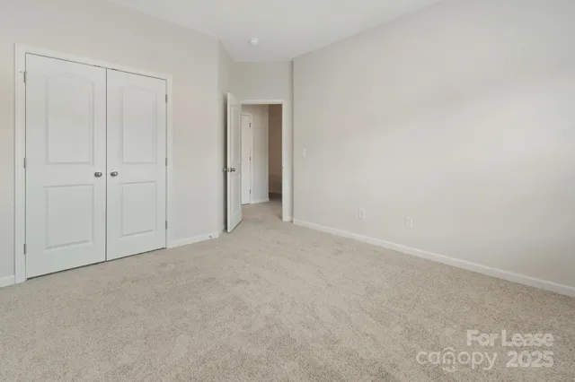 a view of an empty room and closet area