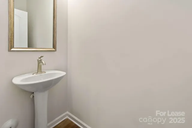 a bathroom with a sink and mirror