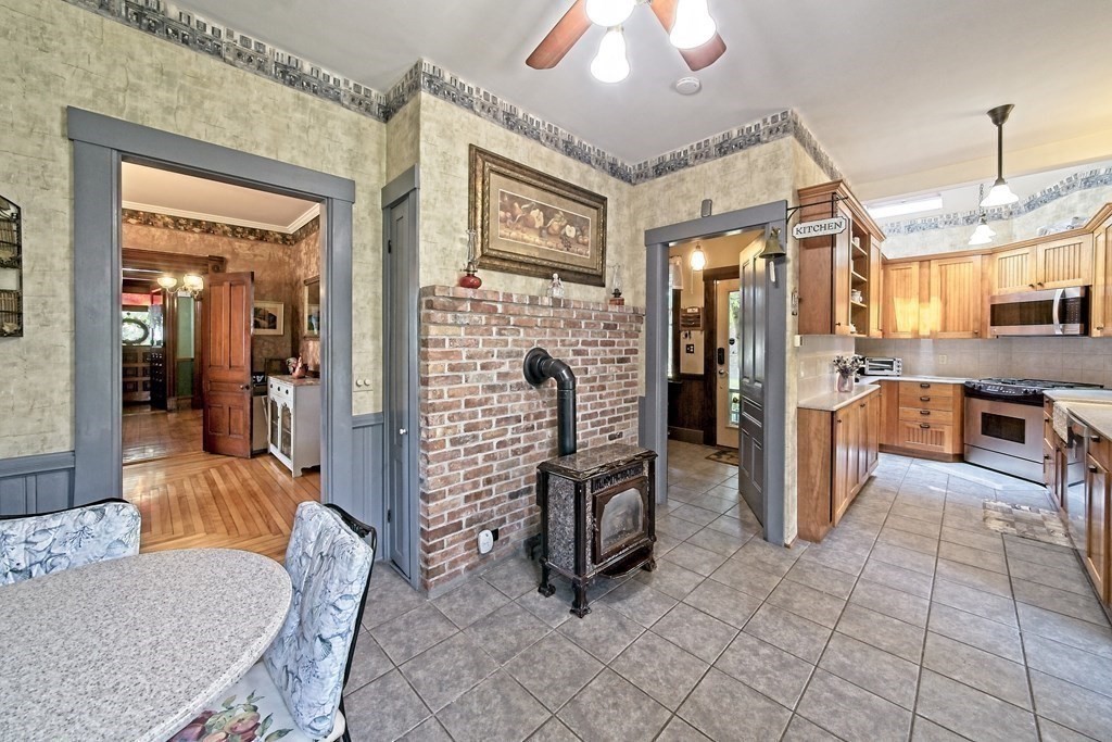138 Walnut Street Clinton, MA 01510 - Photo 13 of 42 a living room with furniture a dining table and a refrigerator