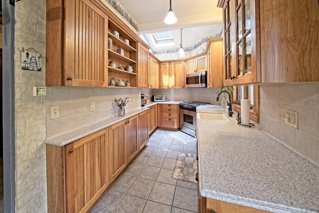 138 Walnut Street Clinton, MA 01510 - Photo 14 of 42 a large kitchen with stainless steel appliances granite countertop a sink and cabinets