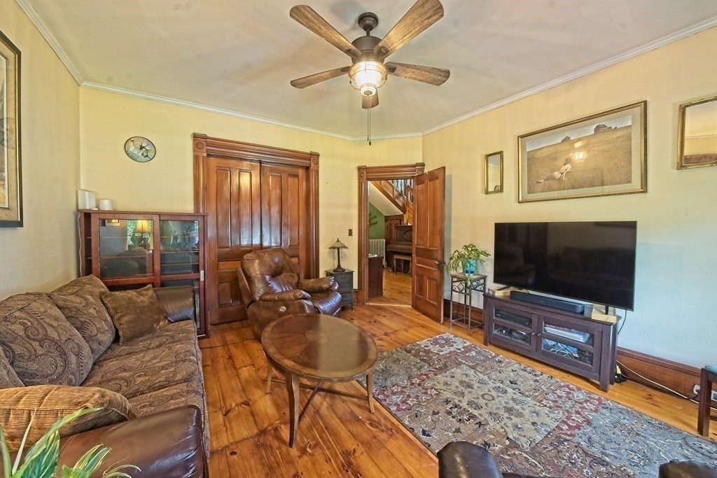 138 Walnut Street Clinton, MA 01510 - Photo 8 of 42 a living room with furniture and a flat screen tv