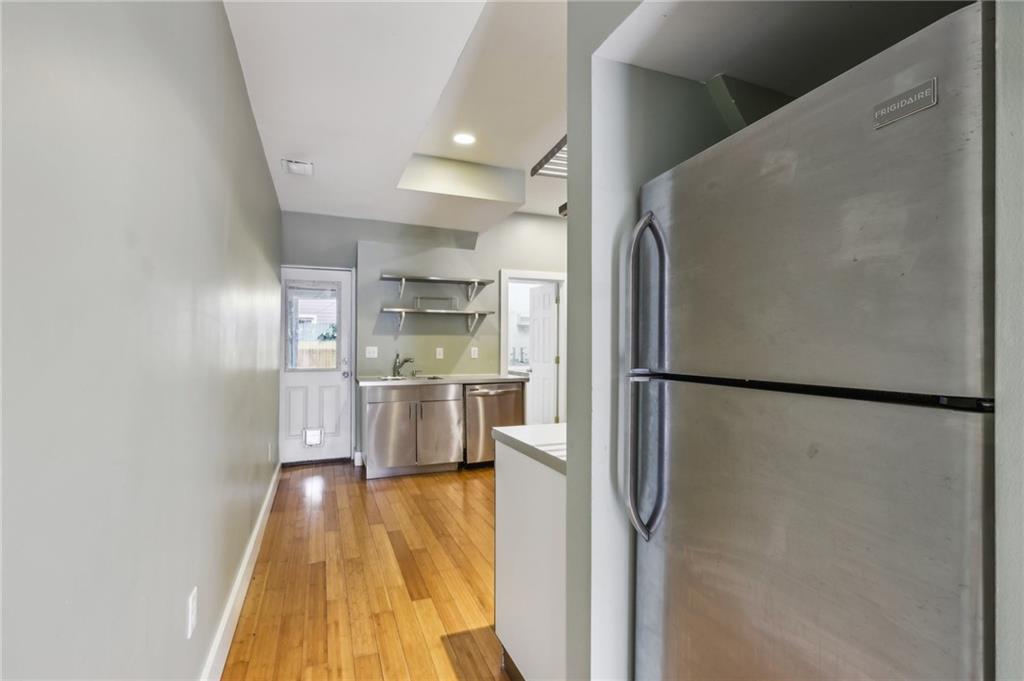176 Lodi Way Pittsburgh, PA 15201 - Photo 11 of 28 a kitchen with stainless steel appliances a refrigerator a sink and white cabinets